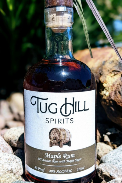 Maple Rum - Tug Hill Estates rum barrel rocks wood outside rum liquor bottle